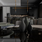 Modern living room with a black and white color scheme, featuring a sofa, coffee table, and decorative vases.